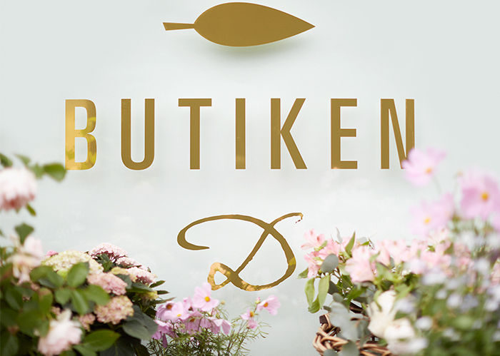 Butiken storefront logotype with flower